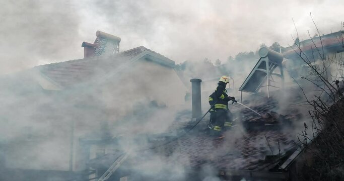 Skopje, Macedonia - 12 Apr, 2021: Firemen in action on burning ruins of building