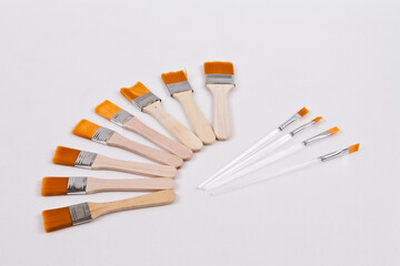 Several small paint brushes were placed on a white background to facilitate background removal