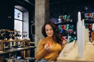 a woman in an electronics store chooses a toothbrush