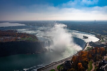 Aerial shot of Niagara Falls and steam rising up on a sunny autumn day