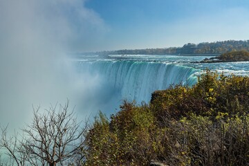 Fototapeta premium Aerial shot of Niagara Falls and thick steam rising above the waterfall