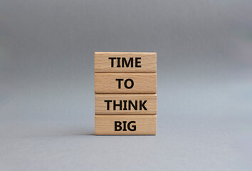 Time to think big symbol. Wooden blocks with words Time to think big. Beautiful grey background....