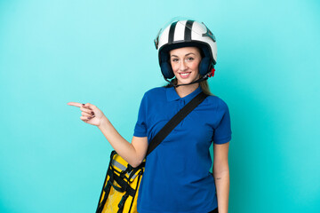 Young caucasian woman with thermal backpack isolated on white background pointing finger to the side