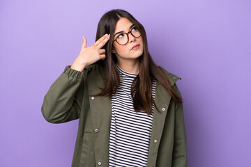 Young Brazilian woman isolated on purple background with problems making suicide gesture