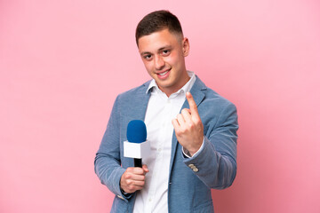Young brazilian presenter man isolated on pink background doing coming gesture