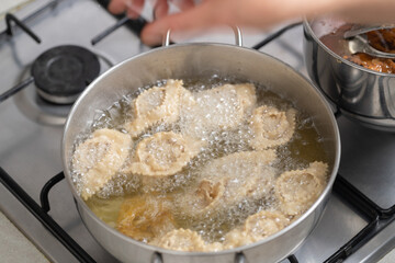 The magic of frying unfolds as chebakia takes a flavorful plunge into the hot oil, creating a crispy, golden exterior.