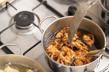 Golden perfection: witness the chebakia dough gracefully sizzle and transform into delectable treats in the frying pan