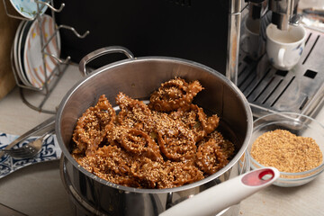 From raw to golden brown: experience the enchanting frying stage that elevates chebakia to culinary excellence