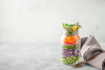 Salad meal prep in a jar, fresh vegetables layered salad. Diet food. Copy space