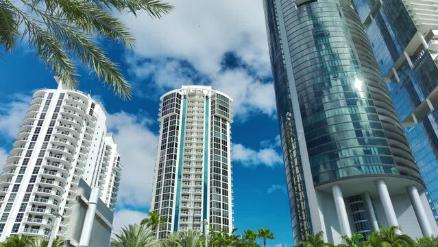 Aerial view of Sunny Isles Beach city with luxurious highrise hotels and condos on Atlantic ocean shore. American tourism infrastructure in southern Florida
