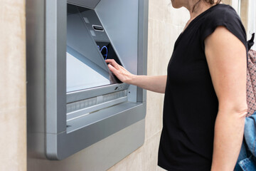 Woman operating an ATM