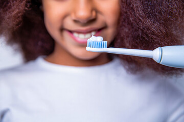 Little girl toothbrush closeup. Little cute african american girl brushing her teeth. Healthy...