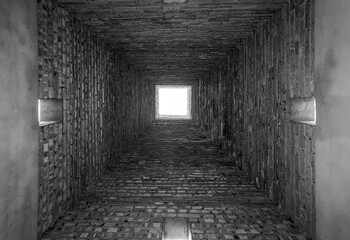 Brick empty small tunnel view, grayscale