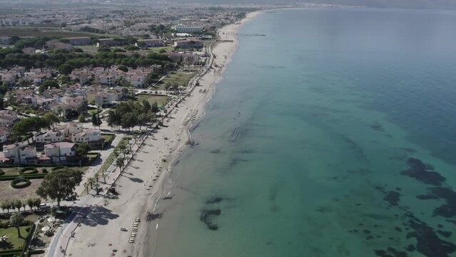 Aerial shot of the Kusadasi Sevgi Beach with urban houses near the coast