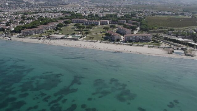 Aerial shot of the Kusadasi Sevgi Beach with urban houses near the coast