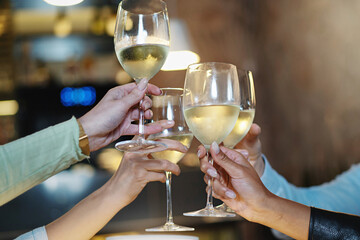 Diverse Hands Toasting with White Wine