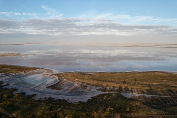 Aerial view of a salt Tyrrell lake, in Australia, with a reflection of a sunset sky on the surface
