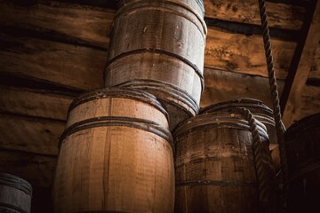 Closeup of the wooden barrels stacked side by side in the wooden room