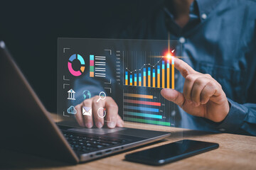 Digital marketing and data management Businessman use laptops to work marketing analysis chart...