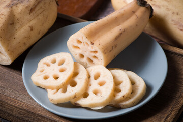 fresh raw lotus root slices on wooden table
