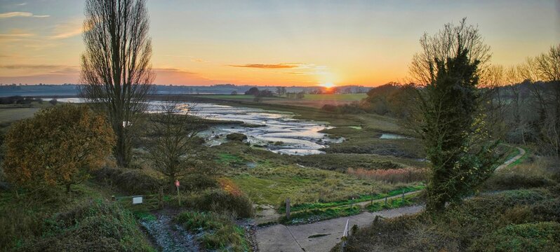 Panoramic aerial view of Levington Lagoon and surrounding greenery at sunset in Suffolk