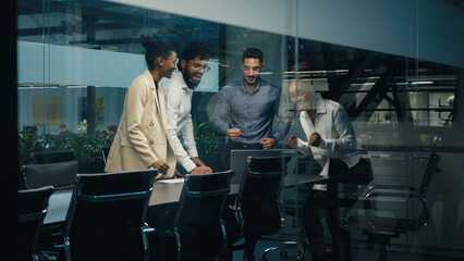 Multi-ethnic diverse business team coworkers colleagues corporate partners workers win with laptop celebrating good online result success winning financial growth together united teamwork partnership