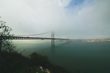 Scenic view of the 25th April Bridge on a cloudy day, Portugal