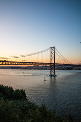 Fototapeta na wymiar Beautiful view of the Ponte 25 de Abril suspension bridge in Portugal during sunset