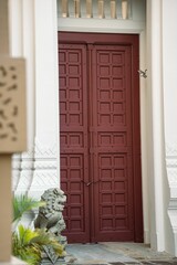 Vertical shot of a red entrance door of a residential building.