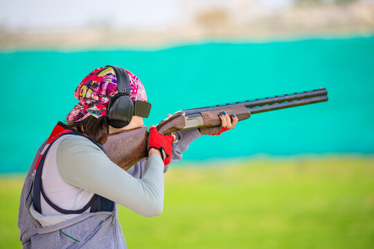 Clay pigeon shooting. An athlete shoots a gun at moving targets, sport gun shooting, clay pigeon shooting. Training process at the shooting range.
