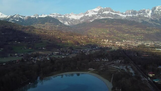 Aerial panning over the Arve valley, town of Sallanches and Passy lake. French Alps early in the morning.