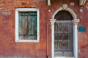Fototapeta na wymiar Reddish rustic exterior of a home in burano italy