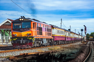 Fototapeta na wymiar Passenger train by diesel locomotive at the railway station.