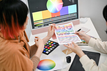 Close-up image of two female graphic designers planning a new project design together