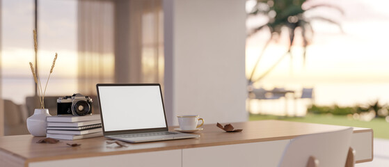 Minimal workspace with laptop mockup on table over blurred background of beautiful outdoor view.