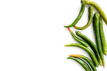 Green hot chili pepper flat lay. Spicy seasoning background