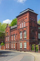 Road leading to a historic red brick house in Essen, Germany