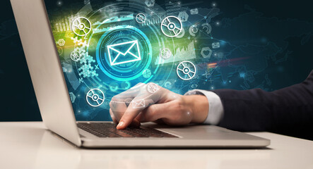 Business hand typing on a modern laptop