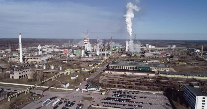 Chemistry Factory in Lithuania, Achema in Jonava City. Clear Blue Sky and Smoke Stacks in Background. Drone
