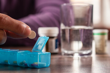 Man take pills from box. Healthcare and old age concept with medicines. Medicaments on table.