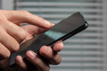 Close up of a man using mobile smart phone