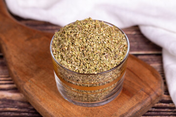 Thyme spice. Dried Thyme leaf in glass bowl on wood floor. Spice concept.