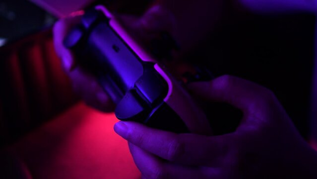 Gamer hands playing a game with gamepad. Close up.