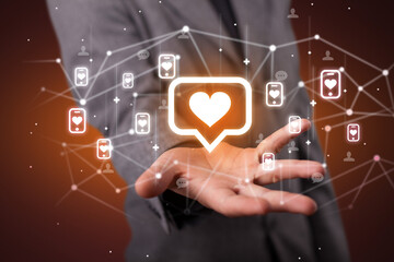 Hand holding social media icons