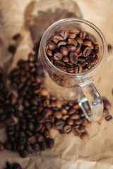 Coffee beans in glass jar on crumpled paper background