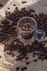 Coffee beans in glass jar on crumpled paper background