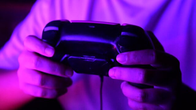 Gamer hands playing a game with gamepad. Close up.