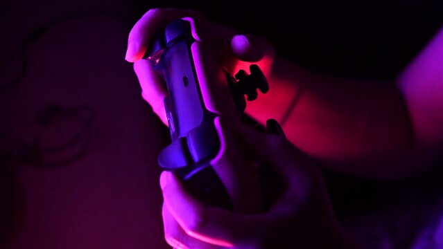 Gamer hands playing a game with gamepad. Close up.
