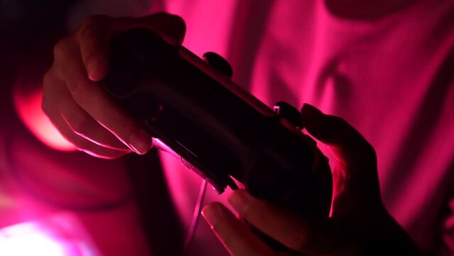 Gamer hands playing a game with gamepad. Close up.