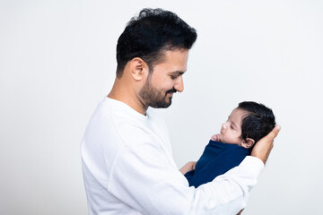Young indian father with cute newborn son in arms. Loving asian dad hug small baby child, Beautiful...